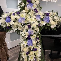 Cross standing spray with lavender flowers for funeral services