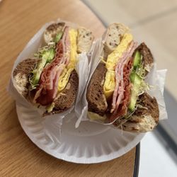 Sam's Bagels - Marble bagel with ham bacon egg and cheese cucumbers and sprouts