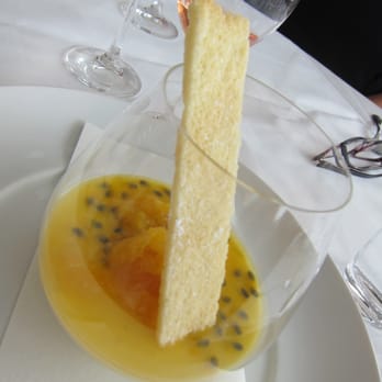 Catalina Restaurant - Vanilla panna cotta with fresh passionfruit; passionfruit and coconut tuile - Restaurants Near Me - Rose Bay, NSW Catalina Restaurant - Vanilla panna cotta with fresh passionfruit; passionfruit and coconut tuile - Restaurants Near Me - Rose Bay, NSW