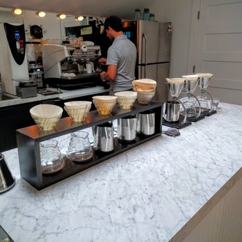 Madcap Coffee - My latte being made in the background. Hot water set to 205 and pour over stations looking great. - Cafes Near Me - Leland, Michigan Madcap Coffee - My latte being made in the background. Hot water set to 205 and pour over stations looking great. - Cafes Near Me - Leland, Michigan