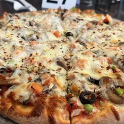 Medium veggie pizza with added crushed red peppers and Parmesan.