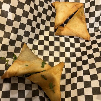 Silver Spoon Restaurant - two pieces of food on checkered paper - Indian Near Me - Allen, Texas Silver Spoon Restaurant - two pieces of food on checkered paper - Indian Near Me - Allen, Texas