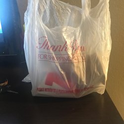 A shopping bag with the food in a brown bag and very cold infull cup of fries very dissatisfied