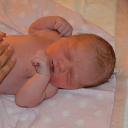 Beautiful Beginnings Homebirth - Photo of midwife's hands examining newborn baby