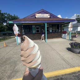 an ice cream cone in front of a building an ice cream cone in front of a building