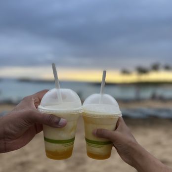 Longboards - two people holding drinks on the beach - Bars Near Me - Kapolei, Hawaii Longboards - two people holding drinks on the beach - Bars Near Me - Kapolei, Hawaii