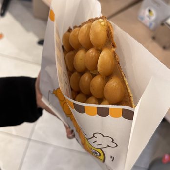 Eggette House - a person holding a bag of eggs - Waffles Near Me - Richmond, British Columbia Eggette House - a person holding a bag of eggs - Waffles Near Me - Richmond, British Columbia