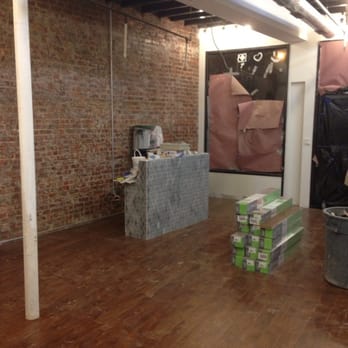 TPG Contracting - a room with a brick wall and wood floors - General Contractors Near Me - Long Island City, New York