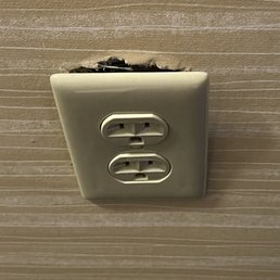 Wall socket hanging out.