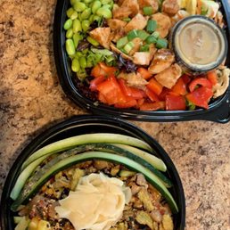 two trays of food on a counter