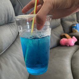 Blue lotus drink with blue raspberry and cupcake