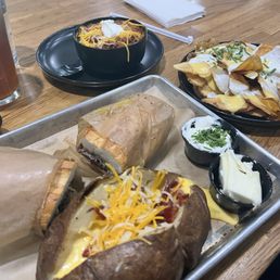 Cheesesteak with loaded baked potato side, BOWL of Chili, potato chicos with cheese sauce