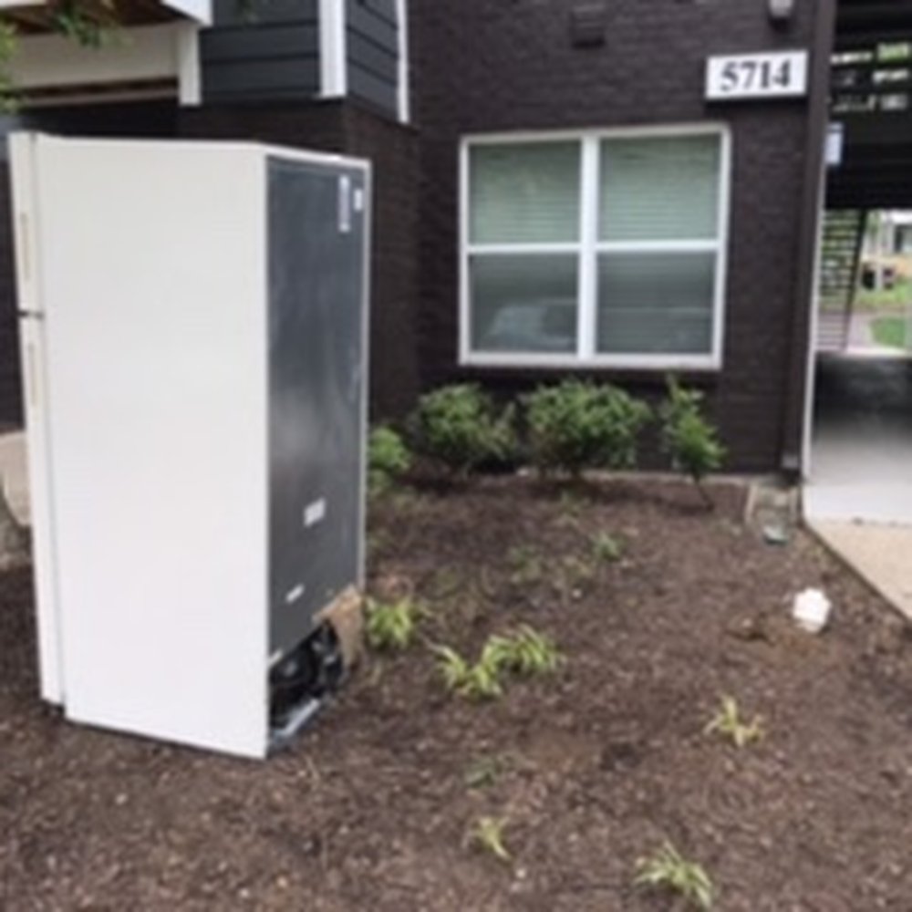 An old refrigerator left sitting outside my building's main entrance over Memorial Day weekend.