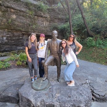 The Jack Daniel Distillery - three women standing in front of a statue - Distilleries Near Me - Lynchburg, Tennessee