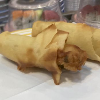 O'Sushi - The worker in the back collected this spring roll (and others) from the belt, microwaved them, and this is the end result. - Sushi Bars Near Me - Hillsboro, Oregon
