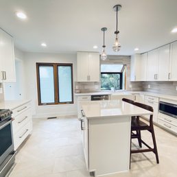 a clean kitchen with white cabinets