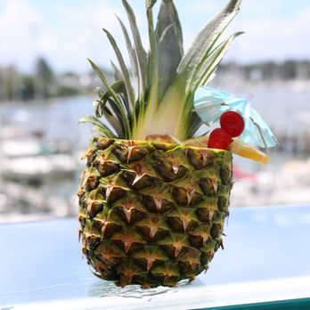 Monroe - a pineapple with a drink in it - Lounges Near Me - Hampton, Virginia