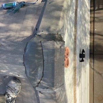 GTR Roofing - Great work! Came in and fixed our ledges for broken shingles they negotiated feast on price and we're super polite and efficient. - A concrete patch is being repaired on a sidewalk, with tools and materials like a caulking gun and clay nearby. - Roofing Near Me - Phoenix, Arizona