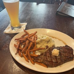 Strip steak with mashed potatoes and sweet potato fries
