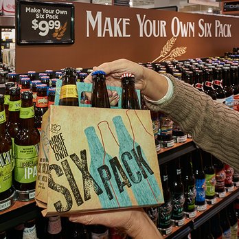 Harris Teeter - a man holding a sign in a store - Grocery Near Me - Germantown, Maryland