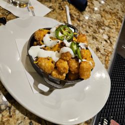 The Sports Page Pub & Grill - Loaded tater tots $13