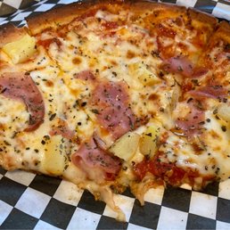 Hawaiian pizza on cauliflower crust, half eaten Hawaiian pizza on cauliflower crust, half eaten