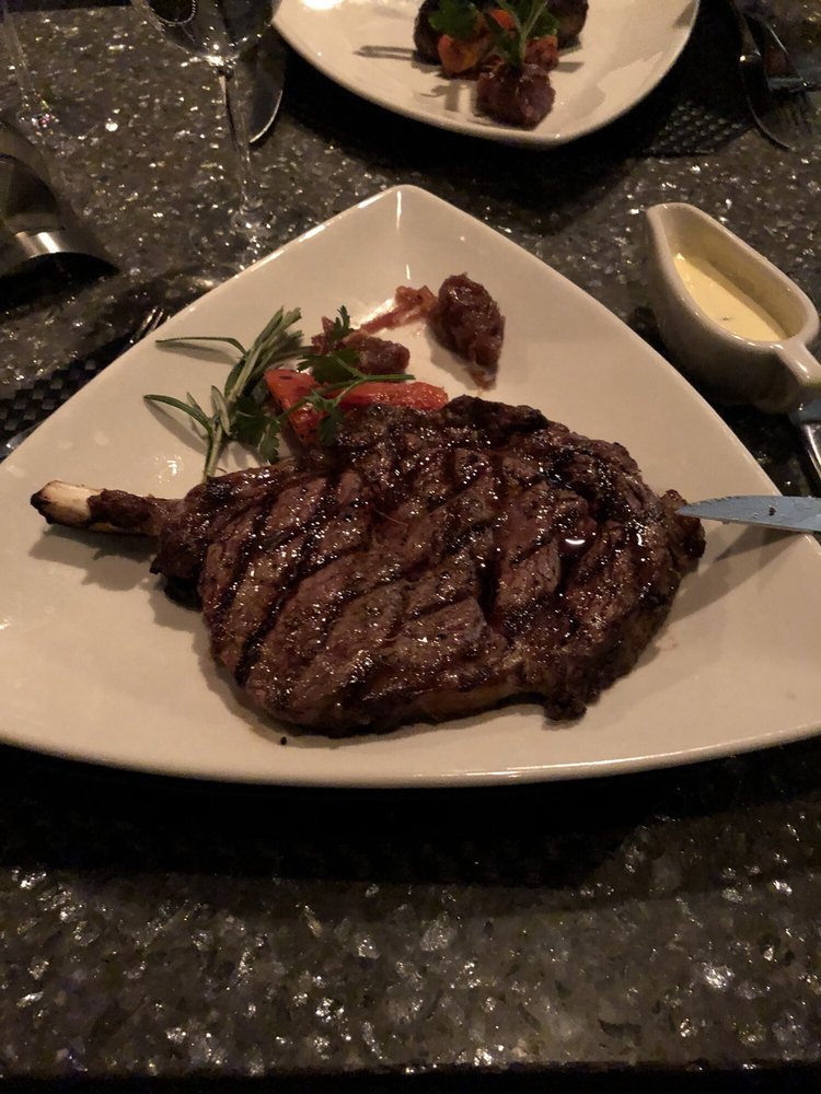 Photo of Nick & Nino's Penthouse Steakhouse - Springfield, IL, United States. Bone in ribeye. Delicious