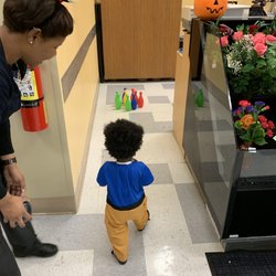 Publix employee and son bowling at candy station