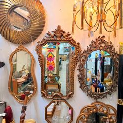 Ornate vintage mirrors and a glowing chandelier bring timeless elegance and old-world charm to this stunning display at AAM Highland.