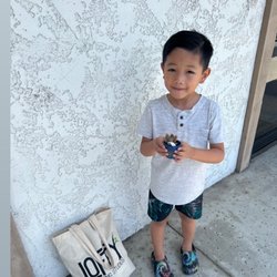 Lofty Learning Studios - My son with the plant he planted and little plater he painted at Lofty!