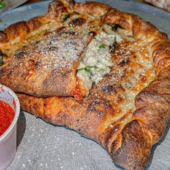 Aviator Pizza & Drafthouse - Spinach & Feta Calzone - Pizza Near Me - Kyle, Texas Aviator Pizza & Drafthouse - Spinach & Feta Calzone - Pizza Near Me - Kyle, Texas