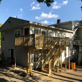 Trusted Home Solutions - a house with a deck and stairs - General Contractors Near Me