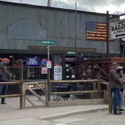 a man standing in front of a saloon