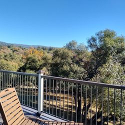 Inn the Woods Suites - Large deck looking out over the beautiful scenery.
