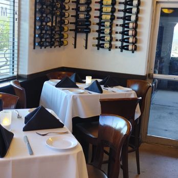 Scuzzi's 1604 - Another wine on the wall, but by a dining table - Italian Near Me - San Antonio, Texas Scuzzi's 1604 - Another wine on the wall, but by a dining table - Italian Near Me - San Antonio, Texas