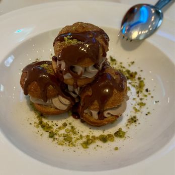 Limani - Profiteroles with chocolate mousse and warm chocolate sauce - Mediterranean Near Me - New York, New York Limani - Profiteroles with chocolate mousse and warm chocolate sauce - Mediterranean Near Me - New York, New York