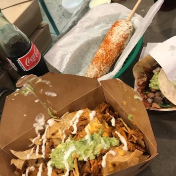 The Taco Stand - Al pastor nachos (half naked) and elote (very salty) - Mexican Near Me - Orange, California The Taco Stand - Al pastor nachos (half naked) and elote (very salty) - Mexican Near Me - Orange, California