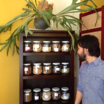 Remedy Wellness Studio - Wylie Huey-owner & acupunctrist in front of his herb collection - Acupuncture Near Me - Oakland, California Remedy Wellness Studio - Wylie Huey-owner & acupunctrist in front of his herb collection - Acupuncture Near Me - Oakland, California