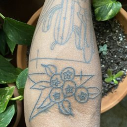 The tattoo with the berries and triangle are from twisted anchor. The tattoo with the berries and triangle are from twisted anchor.