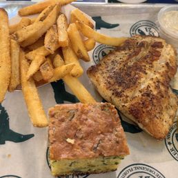 Fish with a side of fries and cornbread Fish with a side of fries and cornbread