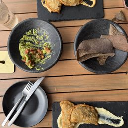 Guacamole and chips (center), mushroom empanadas (bottom), chicken empanadas (top)