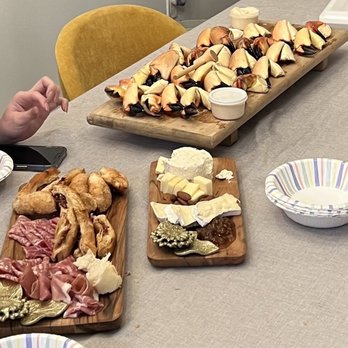 Strictly Stone Crabs - a variety of appetizers on wooden trays - Seafood Markets Near Me