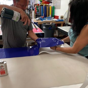 Boss Wraps - Murray working on Carson's helmet - Auto Customization Near Me - Santa Ana, California