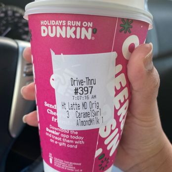 Dunkin' -  a hand holding a cup of coffee - Coffee & Tea Near Me - Lake Alfred, Florida