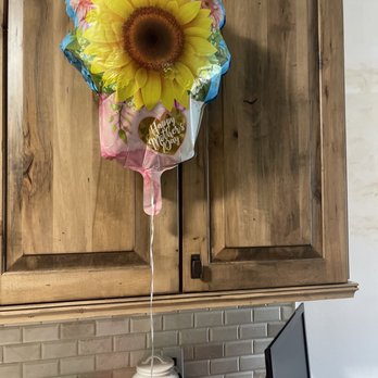 Edible Arrangements - a sunflower balloon attached to a kitchen cabinet - Gift Shops Near Me - Boynton Beach, Florida