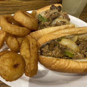 Trident Grill - Philly cheesesteak with onion rings - Sports Bars Near Me - Tucson, Arizona Trident Grill - Philly cheesesteak with onion rings - Sports Bars Near Me - Tucson, Arizona