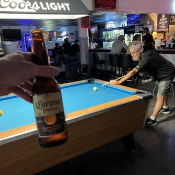 Doctor's Office - a pool table with a bottle of corona light - Nightlife Near Me - Dodge City, Kansas