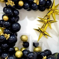 Tasha G Decors - Black and Gold Balloon decor with florals.