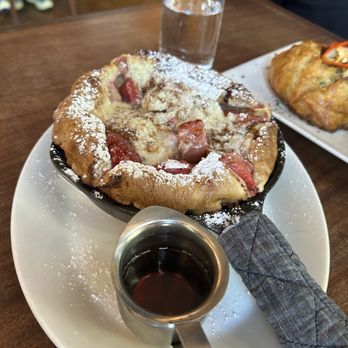 Tilikum Place Cafe - Dutch baby with strawberries and balsamic glaze - New American Near Me - Seattle, Washington Tilikum Place Cafe - Dutch baby with strawberries and balsamic glaze - New American Near Me - Seattle, Washington