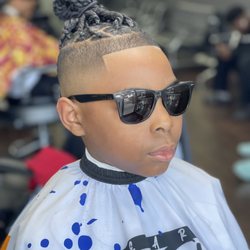 Bald fade with braids on top.